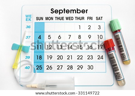 September 2016 planning calendar and blood samples in tubes / blood tubes and needle on the bottom of an appointment calendar of September 2016