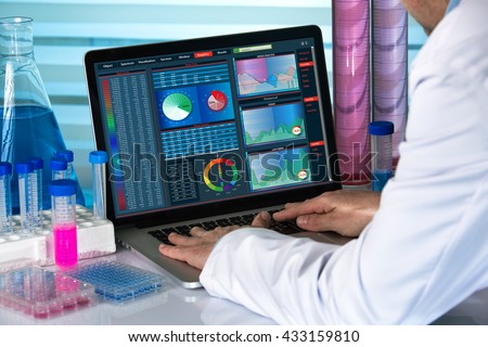 scientist working with laptop in lab / biomedical engineering working with computer in laboratory