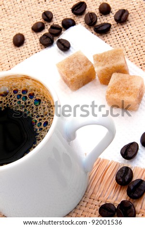 cup of of espresso. coffee beans. pieces sugar