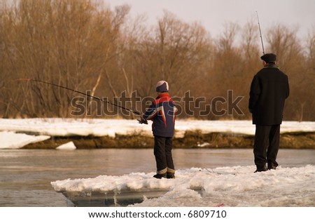 Father and son go fishing on river.