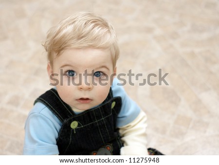 blond child intently peers into camera