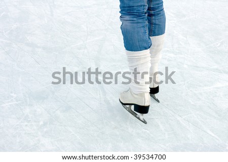 closeup of figure skating ice skates in action outdoors
