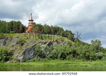 Chapel on the high rocky shore of the Siberian river Tom