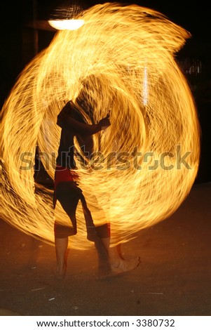 fire performer in a rave party outdoors