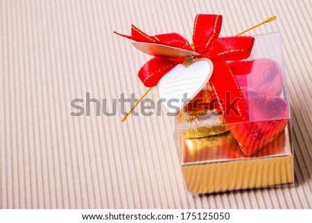 Valentine decoration, heart shaped chocolates box with blank card and red bow