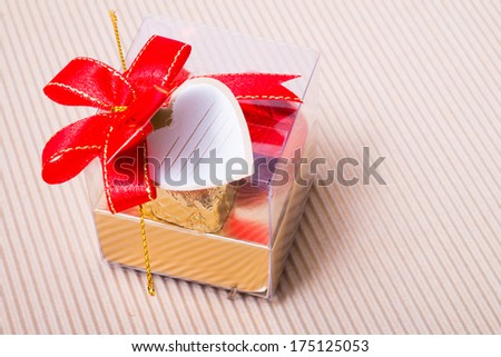 Valentine decoration, heart shaped chocolates box with blank card and red bow