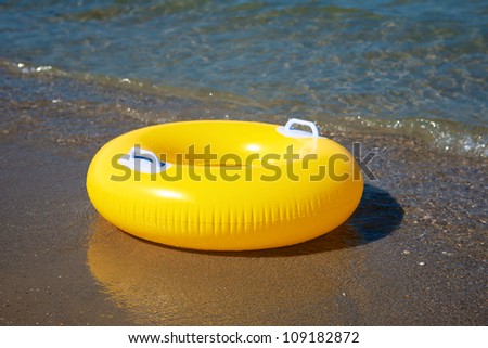 Yellow swim ring floating on a sea
