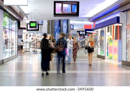 Shoppers at shopping center, motion blur