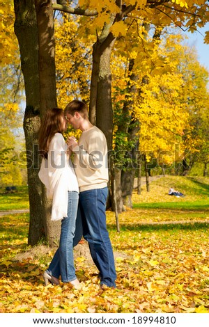 Happy young couple in love meeting in the autumn park
