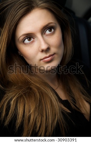 Portrait of beautiful young woman with long hair and big eyes