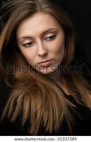 Portrait of beautiful young woman with long hair and big eyes