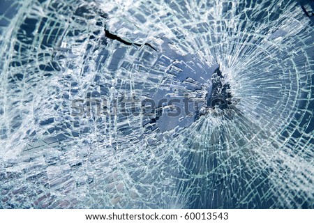 Close-up broken car windshield. Tint blue