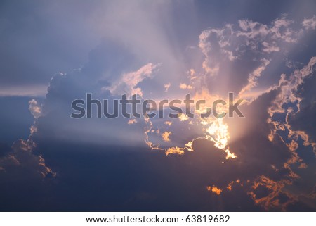 Beautiful sunset in the tropical sea. Sun through clouds