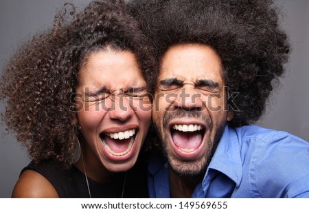 Happy couple doing funny faces in a photo booth