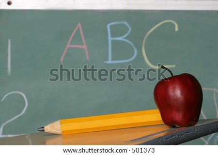 lets learn, chalk board, pencil and apple on desk