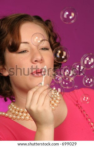 close up of a girl blowing bubbles
