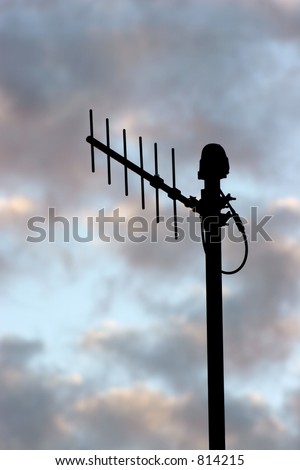 silhouette of microwave antenna on colorful clouds at sunset