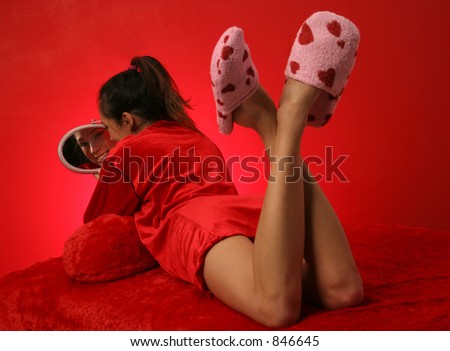 pink heart slippers with her ankles crossed and red robe this girl looks back at you in her mirror