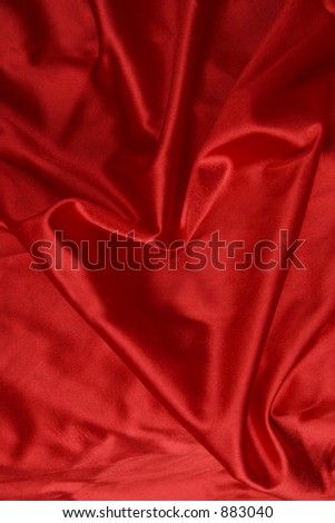 heart formed in the red satin sheets
