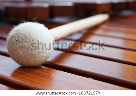 Closeup of a mallet on a wooden marimba