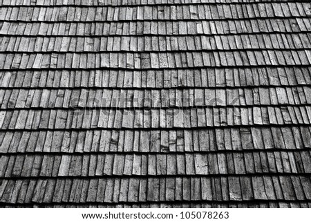 Closeup of an old roof with grey wooden tiles