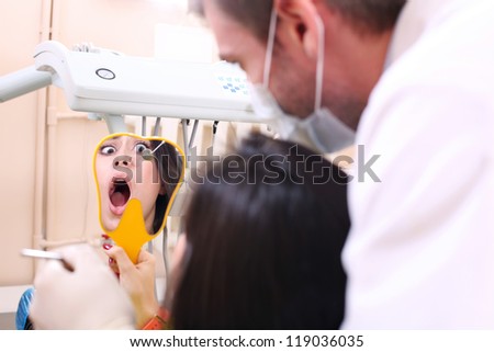 A young girl is afraid to be treated teeth