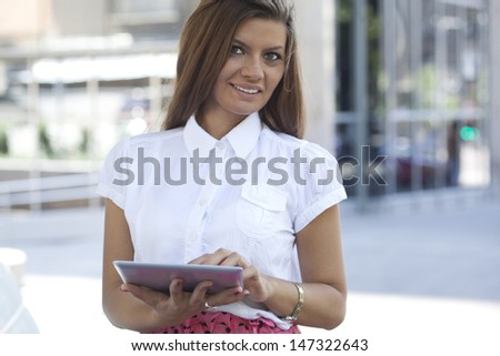 Attractive female business executive busy working on digital tablet