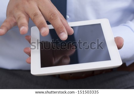 Over the shoulder close-up shot of a hands holding a tablet pc and zooming in a blank screen. Copy space for your ideas.