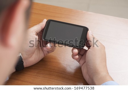 Business person using touch screen smart phone.