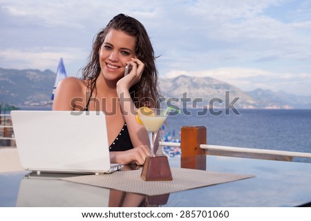 Caucasian woman on the phone with lap top  computer