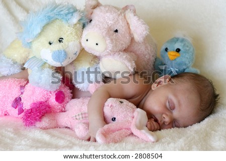 peaceful baby asleep with stuffed toys