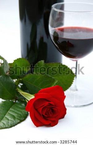 romantic dinner setting - red wine and rose