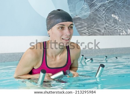 young woman pedal in a training of aquabiking