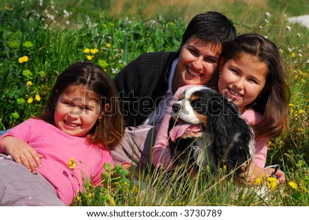 happy family: mother, twins and dog