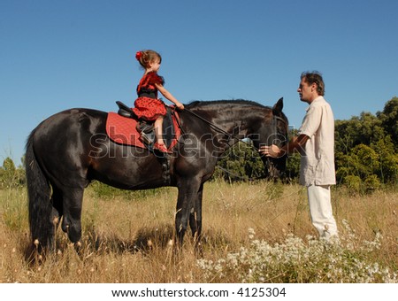 father and his daughter for a training of horseback riding