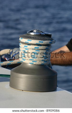 modern winch and rope with a man\'s arm behind