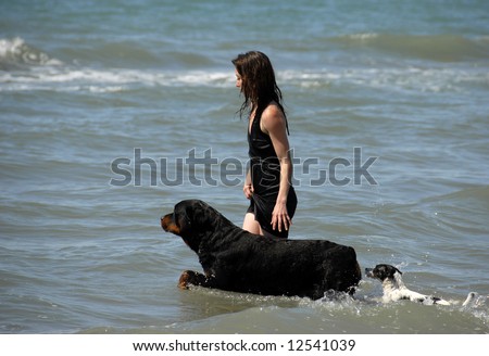 woman and her two dogs on the sea
