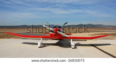 private red plane Robin DR 250 on an airport in the south in France
