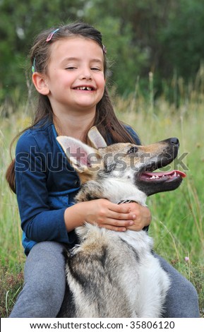 little girl and her baby purebred wolf dog
