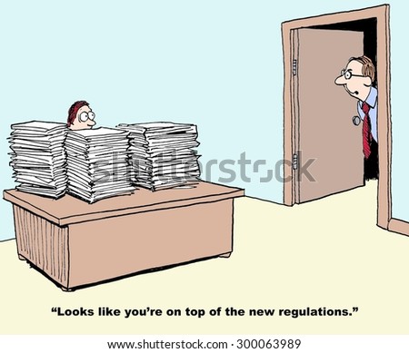 Business or industrial cartoon showing manager with stacks and stacks of paper on his desk and boss saying, \'looks like you\'re on top of the new regulations\'.