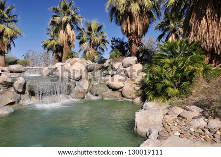 Water spills over rocks into a small pool at a Palm Desert, California city park.