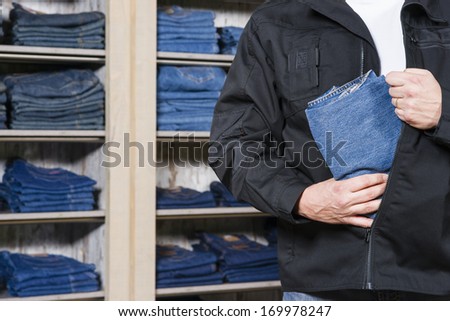 jeans being stolen by a shoplifter in a shop
