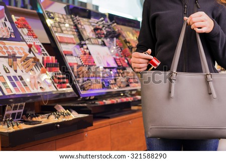 Young woman is stealing goods in a shop