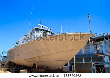 Military boat on repair in dry dock
