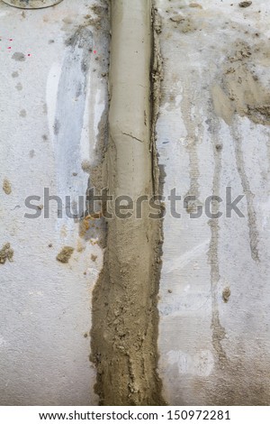 Wet cement on the joint of drainage pipe at construction site
