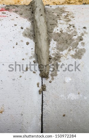 Wet cement on the joint of drainage pipe at construction site