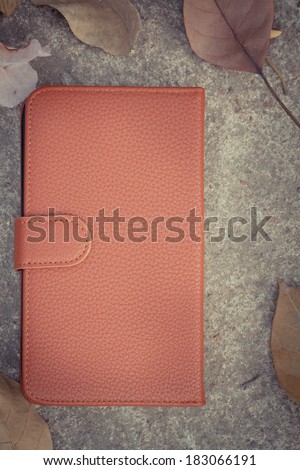 Smart phone case with dried leafs and flower on cement floor