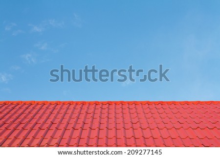 Red roof against blue sky