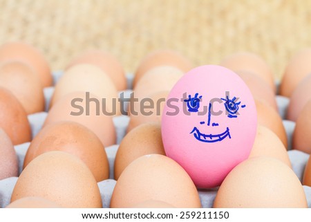 Painted pink preserved egg on fresh eggs