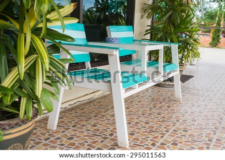Blue and white chairs in front of the house for relaxation